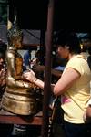 Doi Suthep Temple - Girl Sticking Gold Leaf on Buddha, Chiangmai, Thailand