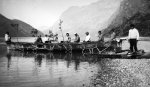 Umiak (decorated with rowan branches) and crew on the shores of Taserssuak Lake [Greenland]