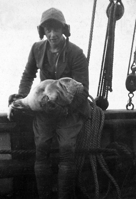Young man holding a seal on the Scotia 